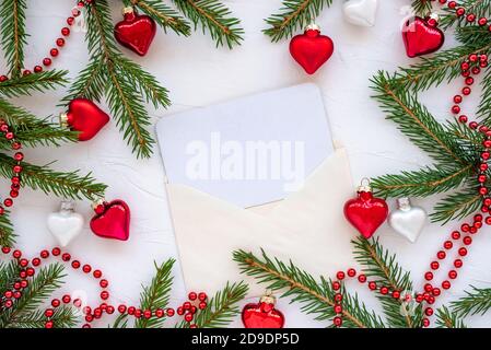 Cartolina di Natale con pini innevati cono giocattolo e lucido sfera Foto Stock