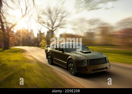 Rendering 3D di un'auto sportiva nera che accelera in un parco urbano. Foto Stock