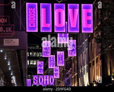 Scegli i cartelli illuminati Love lungo la strada.le luci natalizie di Carnaby Street di quest'anno sono state create in collaborazione con la Charity Choose Love. Foto Stock