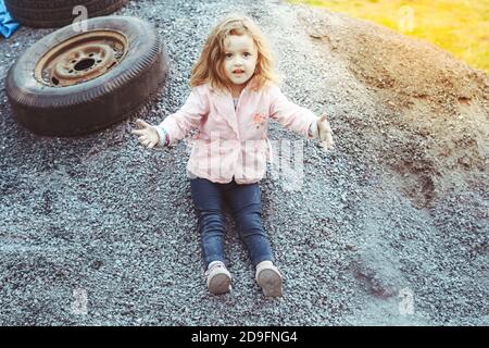 una ragazza gioca in un quartiere povero Foto Stock