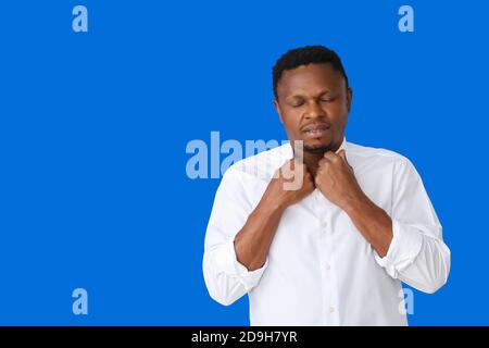 Uomo afroamericano stressato su sfondo a colori Foto Stock