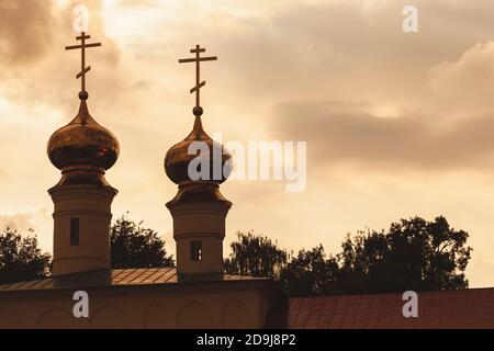 Foto di silhouette della cupola dorata della Cattedrale di Tikhvin di Dormizione in serata. Russia Foto Stock