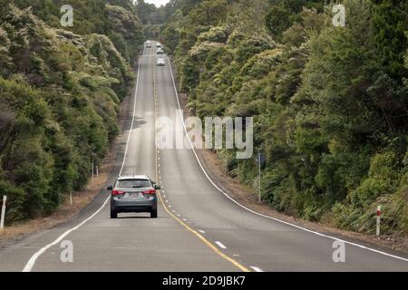 AUCKLAND, NUOVA ZELANDA - 16 gennaio 2020: Auckland / Nuova Zelanda - gennaio 10 2020: Vista dell'auto che guida su una strada collinosa diritta attraverso Waitakere Ranges fo Foto Stock