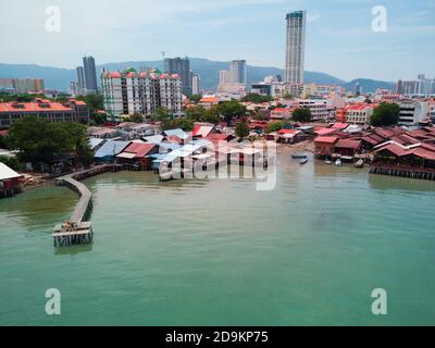 Drone vista di case storiche sull'acqua (pontile clan) e moderna George Town. L'isola di Penang, Malesia. Foto Stock