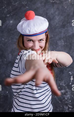 Bella ragazza di mezza età divertirsi in costume da marinaio emozionale ritratto dello studio Foto Stock