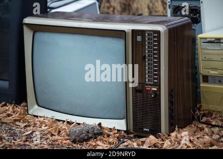 rifiuti di riciclaggio elettronico, pile di vecchi televisori, vecchi computer, vecchia tecnologia in attesa di riciclaggio Foto Stock