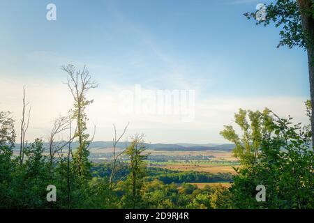 Splendida vista in alto dalla montagna tra gli alberi di molti piccoli villaggi e campi Foto Stock