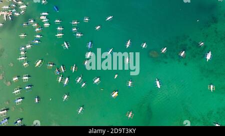 Vista dall'alto della spiaggia di sabbia con acqua di mare turchese e barche locali, foto aerea Foto Stock