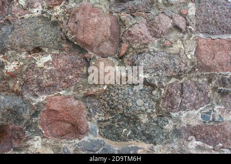 Muro del castello fatto di pietre antiche. Parete del castello fatta di vecchie trame di pietre per il disegno e sfondo della foto. Foto Stock