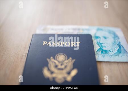 United States of America Passport with a Five Pound Note Parzialmente all'interno Foto Stock