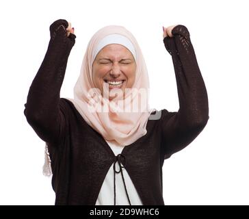 Felice donna musulmana che celebra il successo isolato su bianco Foto Stock