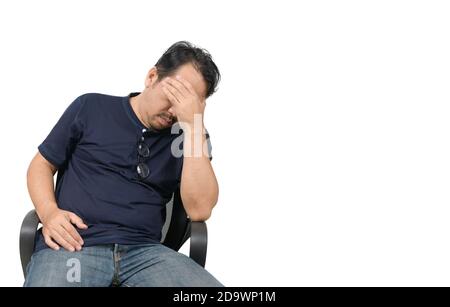 Uomo di mezza età seduto sulla sedia e sensazione di stress e mal di testa isolato su sfondo bianco. Problema e concetto di assistenza sanitaria. Foto Stock