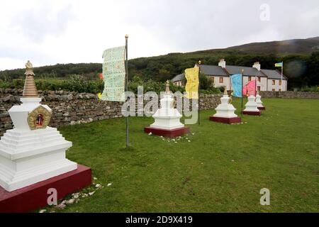 Il Centro per la Pace e la Salute nel mondo, con bandiere e stupidi tibetani su Holy Island, Lamlash Bay, Isola di Arran, Ayrshire, Scozia, Regno Unito Foto Stock