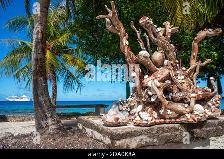 Una scultura con conchiglie su una ringhiera che si affaccia su un tropicale Laguna sull'isola di Fakarava in Polinesia Francese Foto Stock