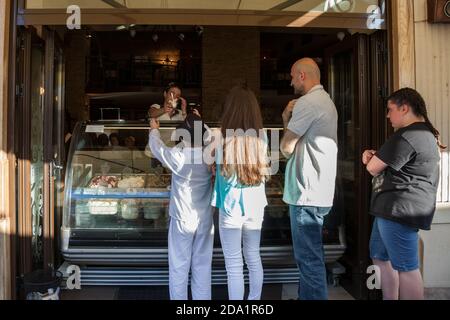 NOVI SAD, SERBIA - 11 GIUGNO 2017: Gelateria che vende gelato italiano a bambini e uomini in una strada pedonale di Novi Sad, Serbia, con zide Foto Stock