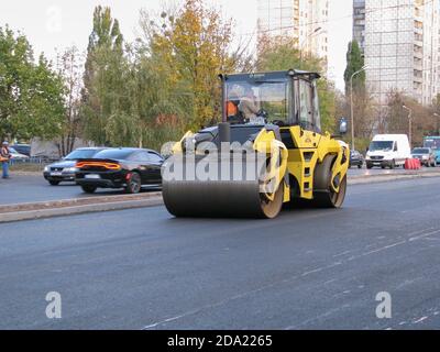 Ucraina, Kharkiv, 27 ottobre 2020. Vista ravvicinata dei lavoratori e delle macchine per l'asfaltatura. Rulli e lavoratori per l'asfaltatura e la riparazione della città Foto Stock