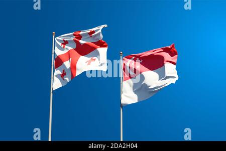 Belle bandiere nazionali di Georgia e Singapore insieme sullo sfondo del cielo. Concetto di grafica 3D. Foto Stock