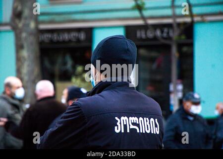 TBILISI, GEORGIA - 08 novembre 2020: Proteste georgiane davanti al Parlamento della Georgia, proteste anti-governative dopo le elezioni. Uomo di polizia. Foto Stock