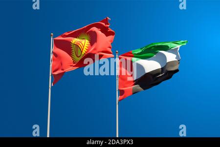 Belle bandiere nazionali di Kirghizistan e Emirati Arabi Uniti insieme sullo sfondo del cielo. Concetto di grafica 3D. Foto Stock