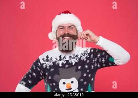 Positività espressa. Uomo bisbigliato felice nel cappello di santa. Festa di nuovo anno. Festeggia le vacanze invernali. Uomo buon natale. in felpa maglia divertente. Shopping natalizio. Moda invernale maschile. Foto Stock