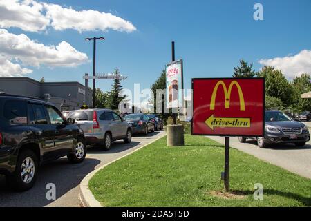 Vancouver, Canada - Luglio 13,2020: Le auto si allineano per ordinare il cibo usando le strutture drive-thru al ristorante locale McDonald's. Foto Stock