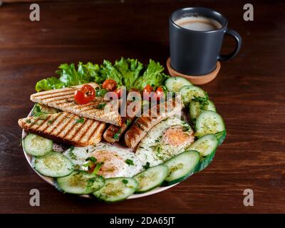 Sminuzzate i panini con salsicce, aneto e un rametto di basilico su un piatto bianco su un tavolo di legno. L'idea di cottura veloce. Primo piano. Foto Stock