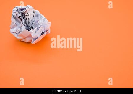 Immagine ad angolo elevato di una sfera di carta avvolta isolata uno sfondo arancione Foto Stock