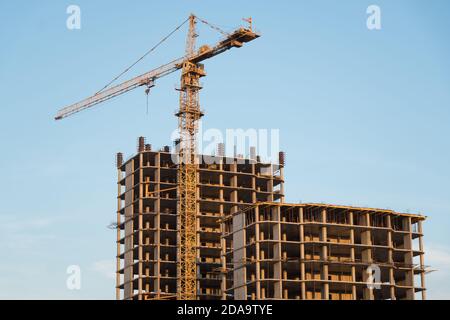Nuovo edificio in costruzione vista dal basso verso l'alto. Un grattacielo incompiuto, una costruzione congelata. Costruzione incompiuta di una residenza a più piani Foto Stock