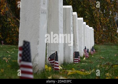 New York City, Stati Uniti. 11 Nov 2020. Per il Veterans Day, le bandiere americane sono collocate ai piedi della lapide dei soldati caduti al Cypress Hills National Cemetery, nel quartiere Brooklyn di New York, NY, il 11 novembre 2020. La data di celebrazione del giorno dei Veterani è stata scelta per commemorare la fine della prima guerra mondiale (prima guerra mondiale), quando l'undicesima ora dell'undicesimo giorno dell'undicesimo mese del 1918, i combattimenti si sono fermati dopo che la Germania ha firmato un armistizio. (Anthony Behar/Sipa USA) Credit: Sipa USA/Alamy Live News Foto Stock