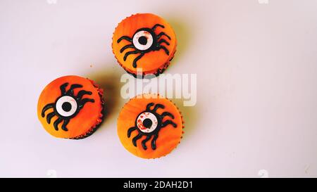 I cupcakes di Halloween Spider ricoperti di fondante arancione, fuoco selettivo Foto Stock