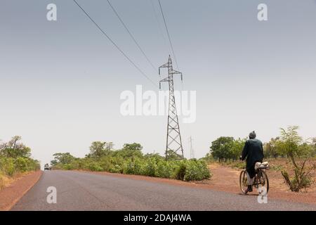 Selingue, Mali, 25 aprile 2015; i piloni elettrici distribuiscono energia dalla diga di Seligue. Foto Stock