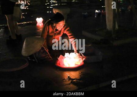 Un'antica donna vietnamita che fa e vende lanterne galleggianti per l'uso sul fiume Thu Bon, Hoi An, Vietnam, Asia Foto Stock
