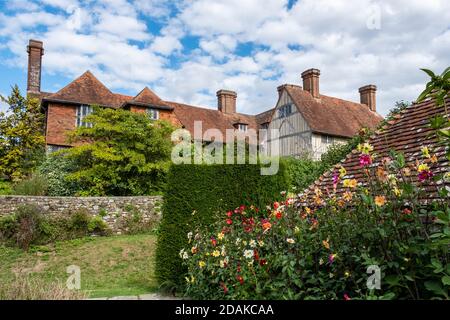 Great Dixter House and Garden, Northiam, East Sussex, Inghilterra, Regno Unito, GB. Dahlias colorati piantati intorno agli annessi. Foto Stock