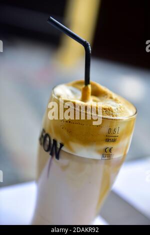 Bicchiere di caffè ghiacciato con paglia Foto Stock