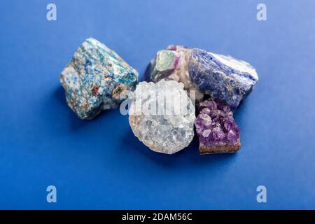 Set di primo piano minerali naturali, pietre preziose su sfondo blu classico. Utilizzare per gioielli. Spazio per il testo. Foto Stock