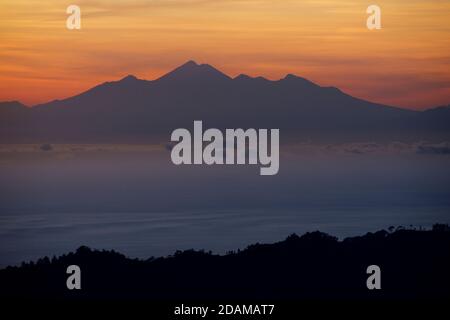 Monte Rinjani a Lombok e lo stretto di Lombok visto da una salita del Monte Batur, Bali, Indonesia Foto Stock