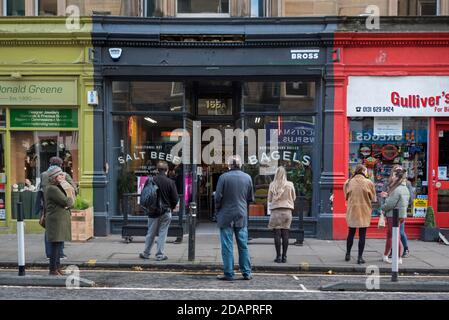 Coda socialmente distanziata durante la pandemia del coronavirus che attende fuori da un negozio di bagel a Bruntsfield, Edimburgo, Scozia, Regno Unito. Foto Stock