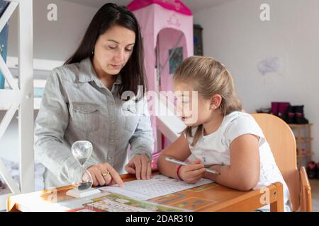 Madre e figlia al controllo dei compiti, scuola domestica, Schliersee, Baviera, Germania Foto Stock