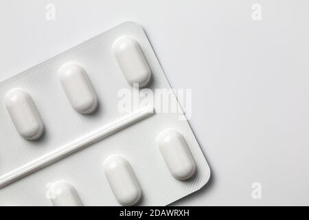 Confezione di blister angolato non utilizzata di pillole isolate su sfondo bianco. Medicine pillole farmaco semplice Foto Stock