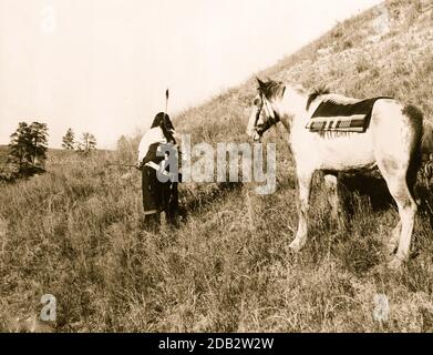 Vista posteriore del fucile da trasporto indiano Sioux di fronte al pony.. Foto Stock