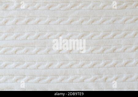 Sfondo in lana beige. Tessuto di maglieria. Sfondo minimalismo scandinavo con spazio copia, vista dall'alto Foto Stock