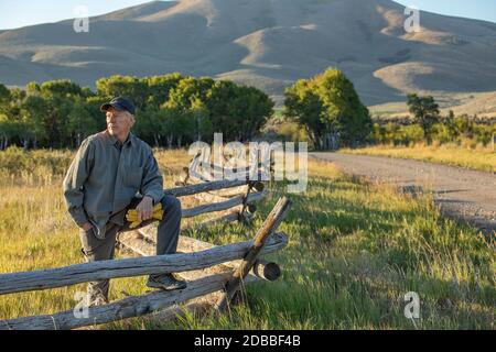 USA, Idaho, Bellevue, contadino che pende contro la recinzione sul campo Foto Stock