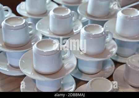 Le tazze da caffè pulite si impilano in un bar, non ci sono ospiti Foto Stock