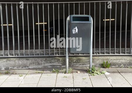 Pattumiera nella fermata dell'autobus vicino a un parcheggio Foto Stock