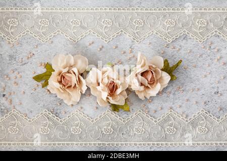 Disposizione di nozze posata su tavolo decorato con rose. Foto Stock