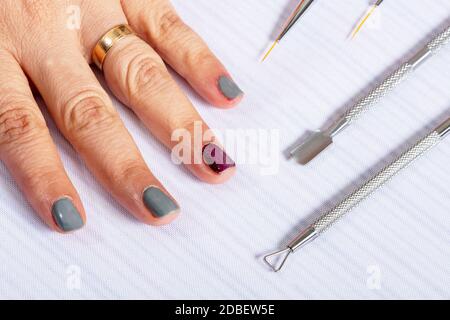 mani di manicure che lavorano con materiali e attrezzi Foto Stock