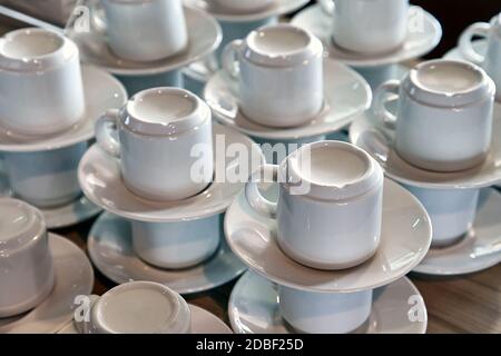 Le tazze da caffè pulite si impilano in un bar, non ci sono ospiti Foto Stock