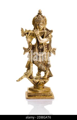 Krishna dio Vishnu avatar statua di ottone isolato su bianco con riflessione Foto Stock