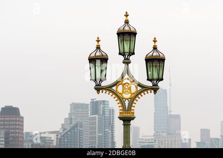 Lampade di strada sul Westminster Bridge, grattacieli fioriti sullo sfondo, Londra, UK - immagine Foto Stock
