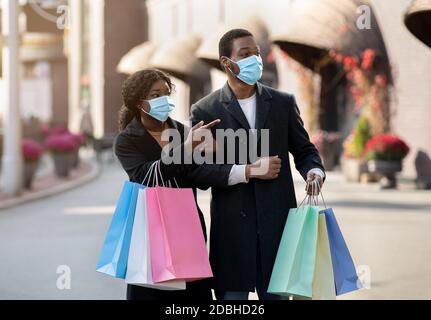 Fare shopping insieme, con maschera viso durante covid-19 Foto Stock